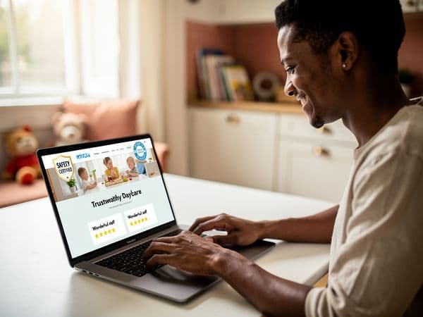 Concerned mother reviewing daycare website on laptop